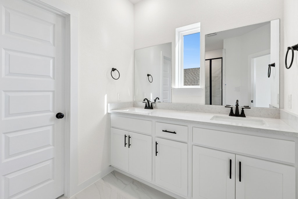 4737 Pleasant Place Round Rock, TX 78665 - Photo 19 of 30 a bathroom with a sink and a mirror