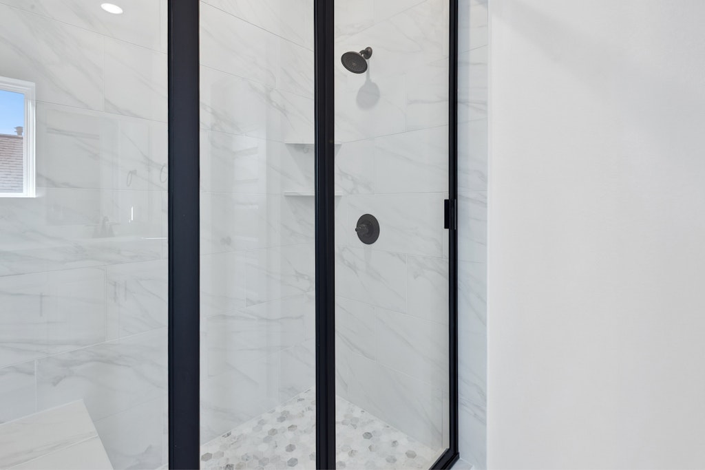 4737 Pleasant Place Round Rock, TX 78665 - Photo 20 of 30 a bathroom with a glass shower door