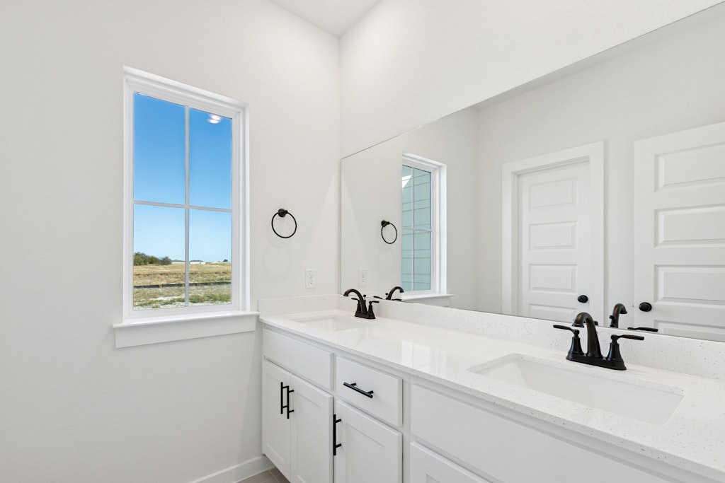 4737 Pleasant Place Round Rock, TX 78665 - Photo 23 of 30 a bathroom with a sink and a mirror