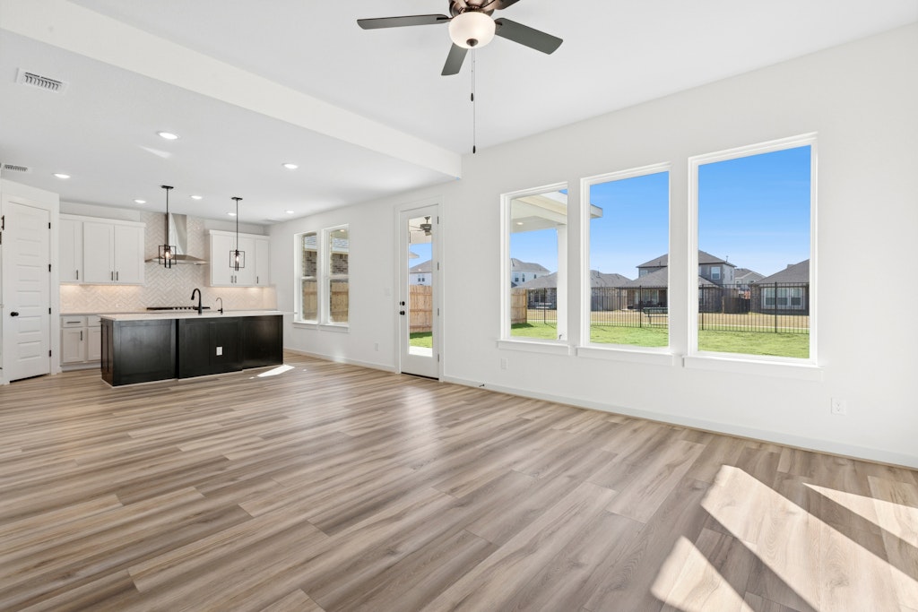 4737 Pleasant Place Round Rock, TX 78665 - Photo 7 of 30 a view of kitchen and window with wooden floor