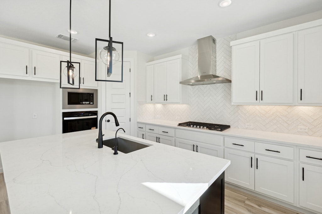 4737 Pleasant Place Round Rock, TX 78665 - Photo 9 of 30 a kitchen with stainless steel appliances granite countertop a sink a stove and a refrigerator