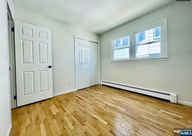 a view of a room with wooden floor and cabinet