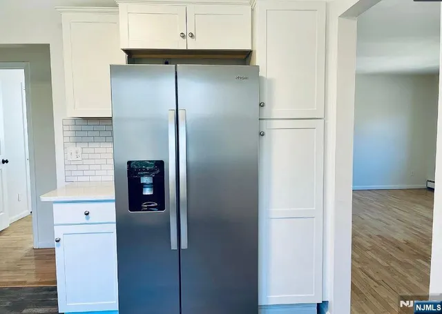a kitchen with a refrigerator and a stove