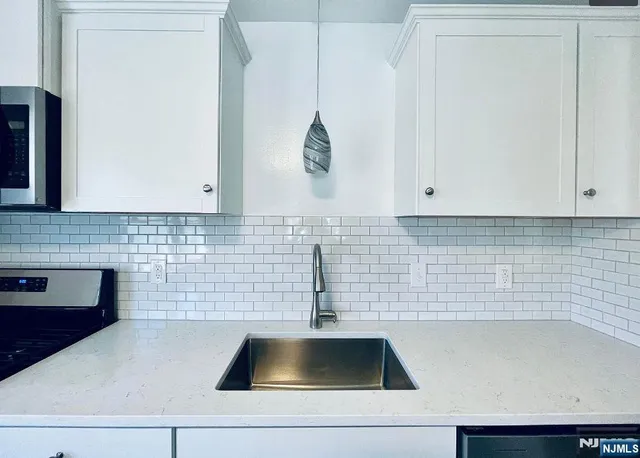 a kitchen with a sink and cabinets