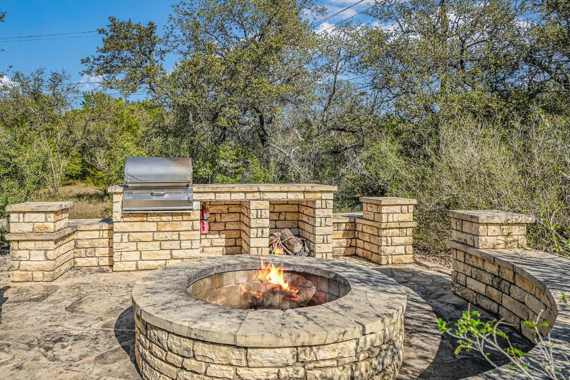 4307 Eck Lane, Unit 107 Austin, TX 78734 - Photo 27 of 28 a backyard of a house with table and chairs and wooden floor