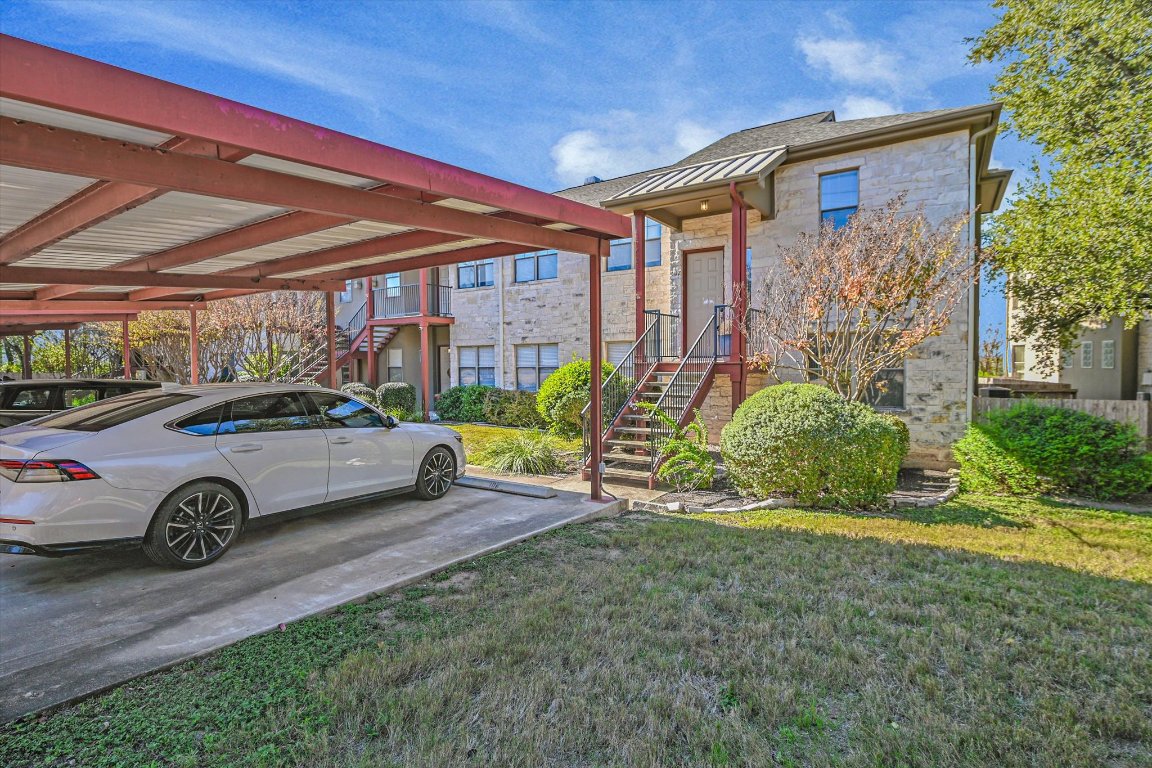 4307 Eck Lane, Unit 107 Austin, TX 78734 - Photo 3 of 28 a front view of a house with a yard