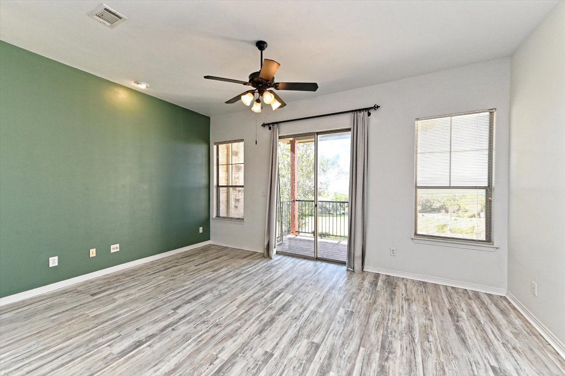 4307 Eck Lane, Unit 107 Austin, TX 78734 - Photo 5 of 28 a view of an empty room with a window and wooden floor