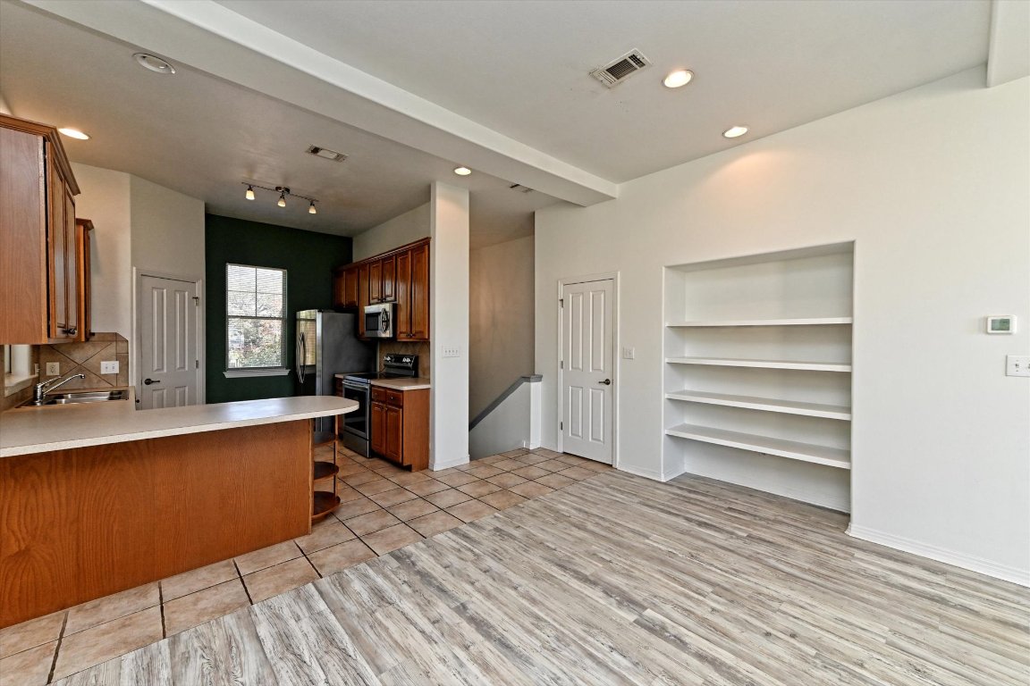 4307 Eck Lane, Unit 107 Austin, TX 78734 - Photo 9 of 28 a large space with a large window and wooden floor