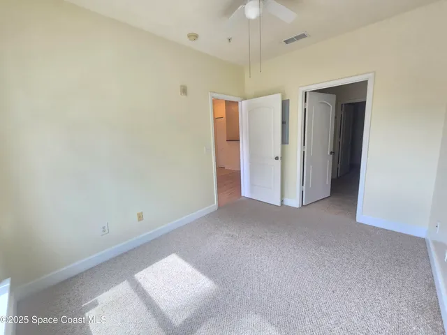 a view of a patio with table and chairs and a large tree
