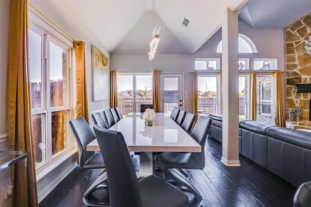 a view of a dining room with furniture large windows and wooden floor