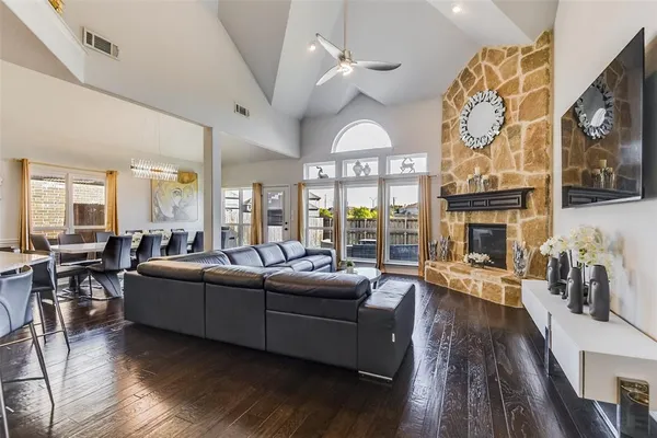 a living room with fireplace furniture and a large window