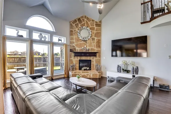 a living room with furniture a large window and a flat screen tv