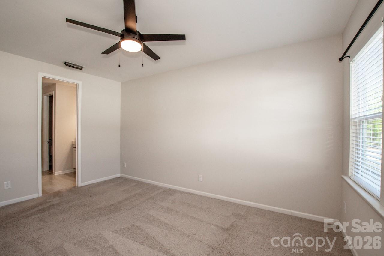 1270 Brawley School Road, Unit F Mooresville, NC 28117 - Photo 23 of 37 an empty room with a window and a fan