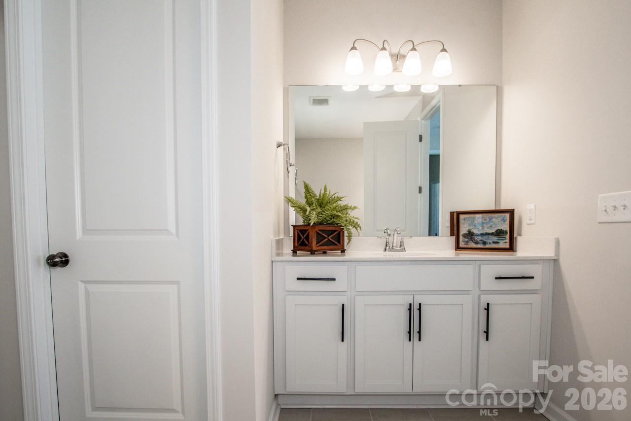 1270 Brawley School Road, Unit F Mooresville, NC 28117 - Photo 25 of 37 a bathroom with a sink and a mirror