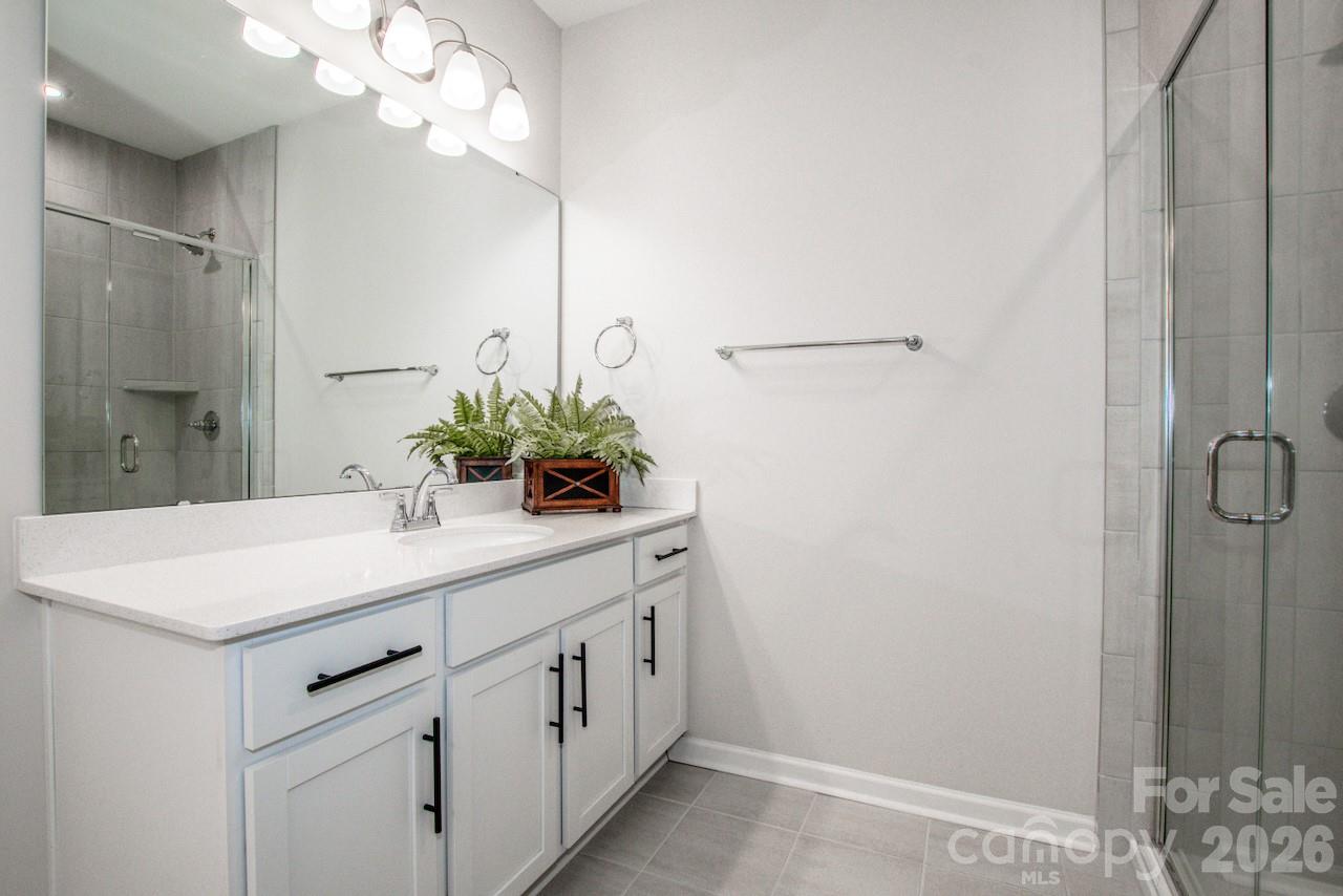 1270 Brawley School Road, Unit F Mooresville, NC 28117 - Photo 26 of 37 a bathroom with a sink vanity and a mirror