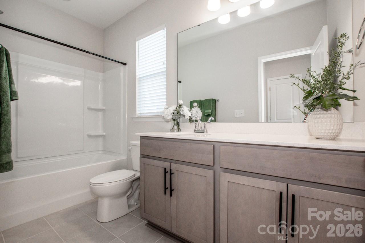 1270 Brawley School Road, Unit F Mooresville, NC 28117 - Photo 30 of 37 a bathroom with a sink a toilet and shower