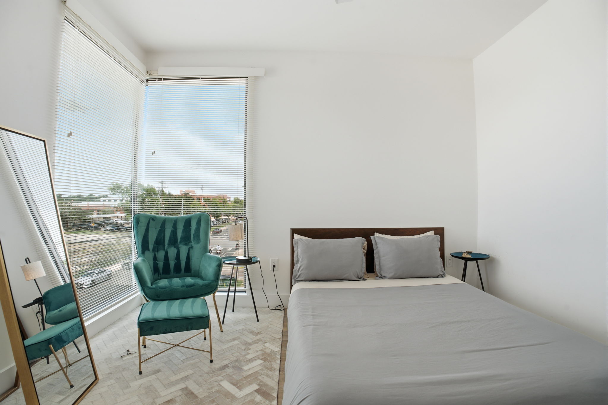 2709 East 5th Street, Unit 1306 Austin, TX 78702 - Photo 19 of 28 Herringbone flooring and ample natural light define this cozy sleeping area.