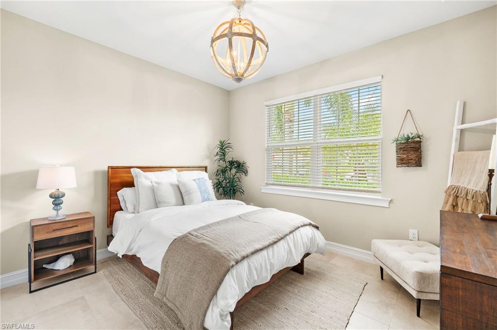 14546 Tropical Drive Naples, FL 34114 - Photo 18 of 38 a bedroom with bed and a window