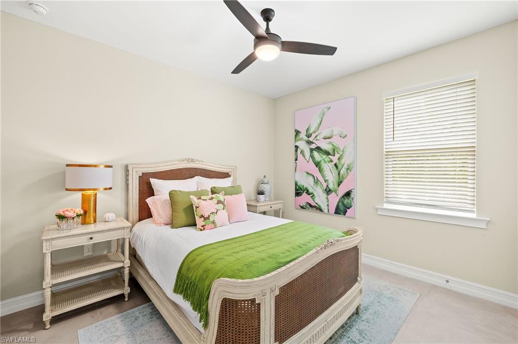 14546 Tropical Drive Naples, FL 34114 - Photo 19 of 38 a bedroom with a bed and a window