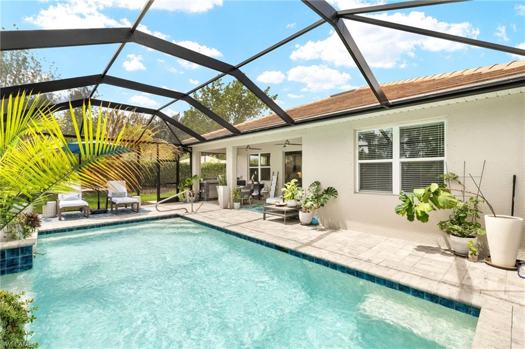 14546 Tropical Drive Naples, FL 34114 - Photo 25 of 38 a view of swimming pool with outdoor seating