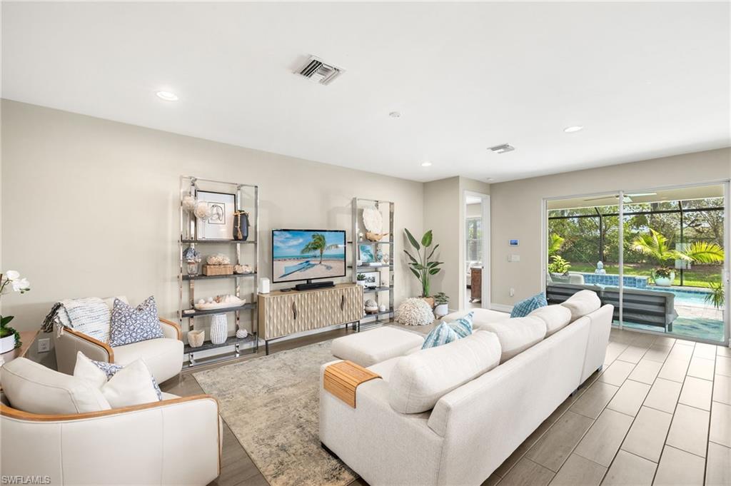 14546 Tropical Drive Naples, FL 34114 - Photo 5 of 38 a living room with furniture and a flat screen tv