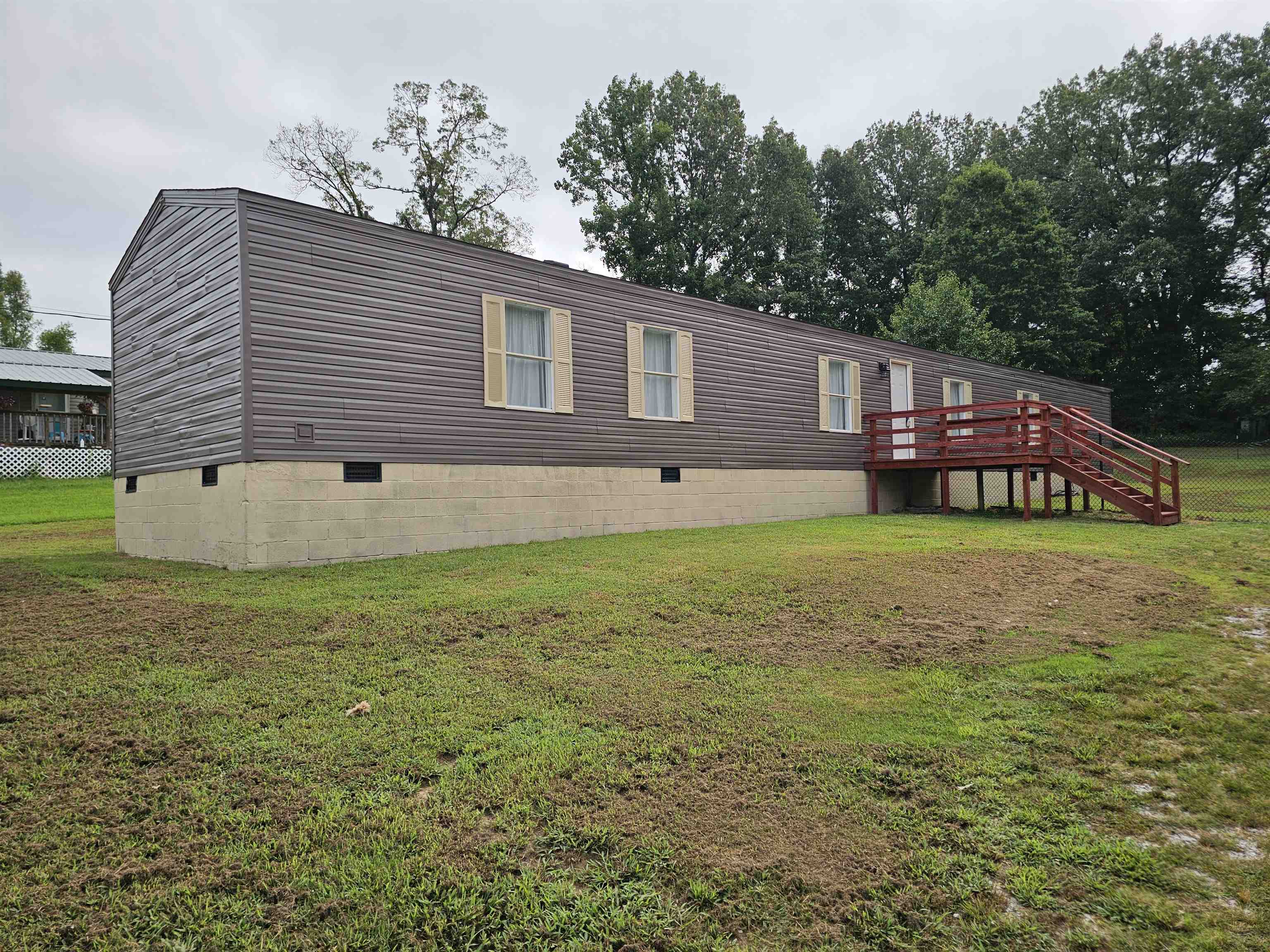 474 Fite Road Munford, TN 38058 - Photo 3 of 19 View of front of property featuring crawl space, a deck, a front lawn, and stairway