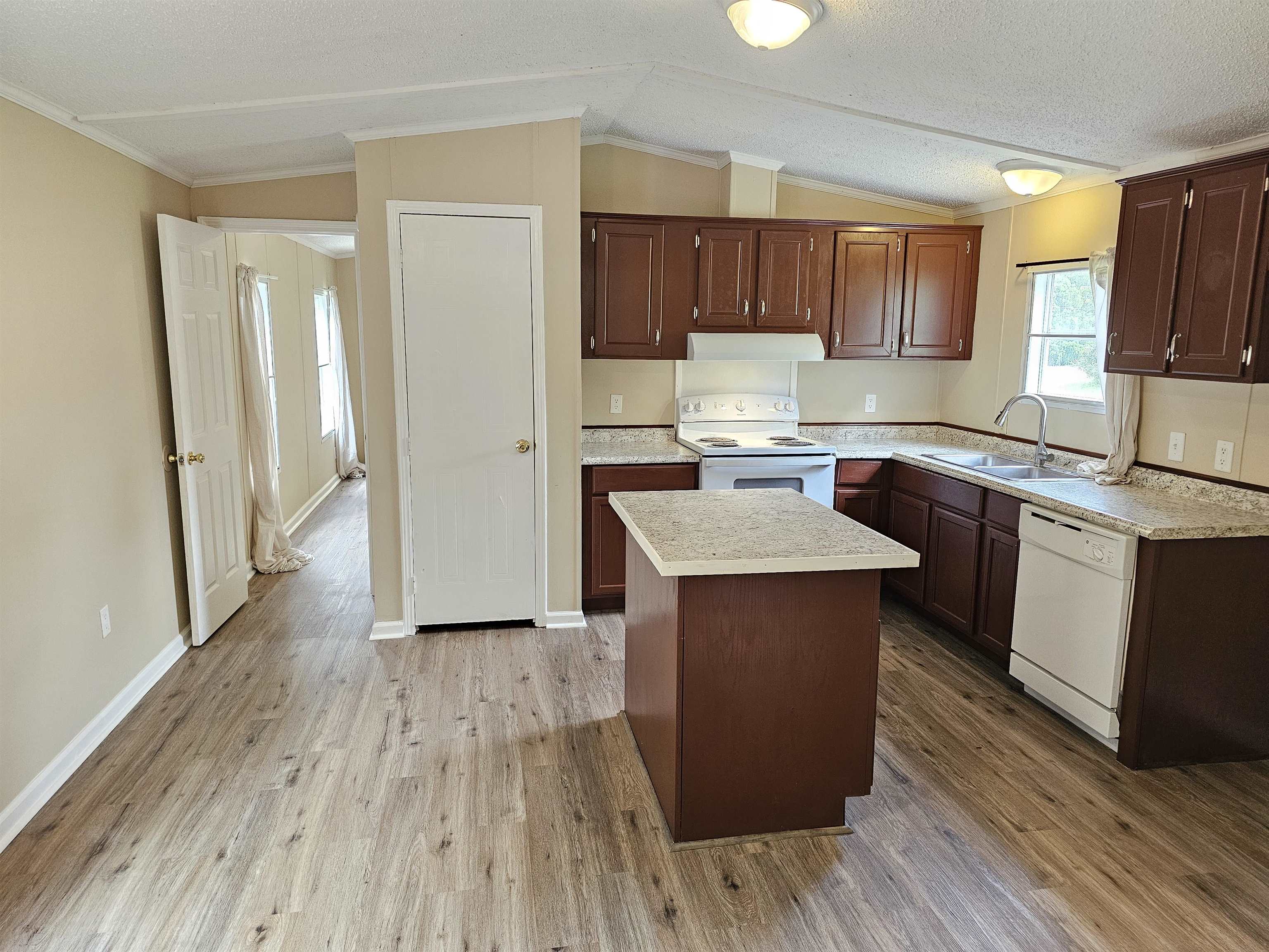 474 Fite Road Munford, TN 38058 - Photo 5 of 19 Kitchen with vaulted ceiling, white appliances, light countertops, ornamental molding, and a kitchen island