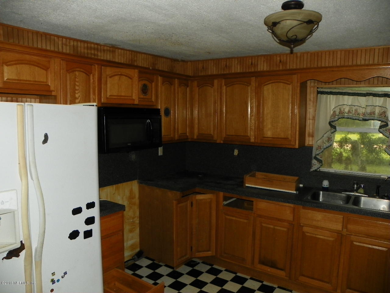 44084 Hendricks Trail Callahan, FL 32011 - Photo 3 of 9 a kitchen with a refrigerator and a stove