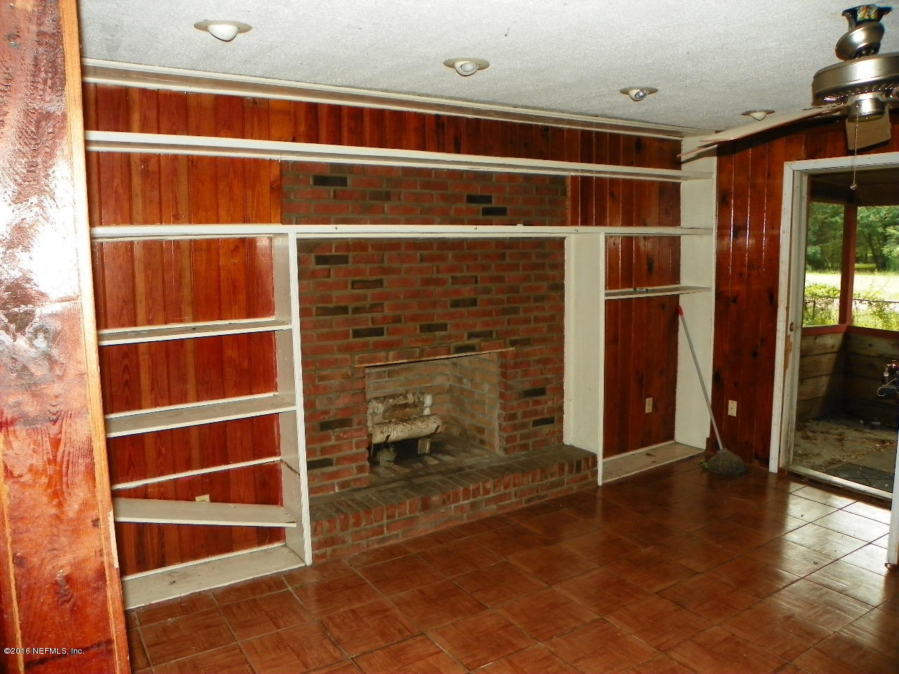 44084 Hendricks Trail Callahan, FL 32011 - Photo 4 of 9 a view of an empty room with wooden floor and a window