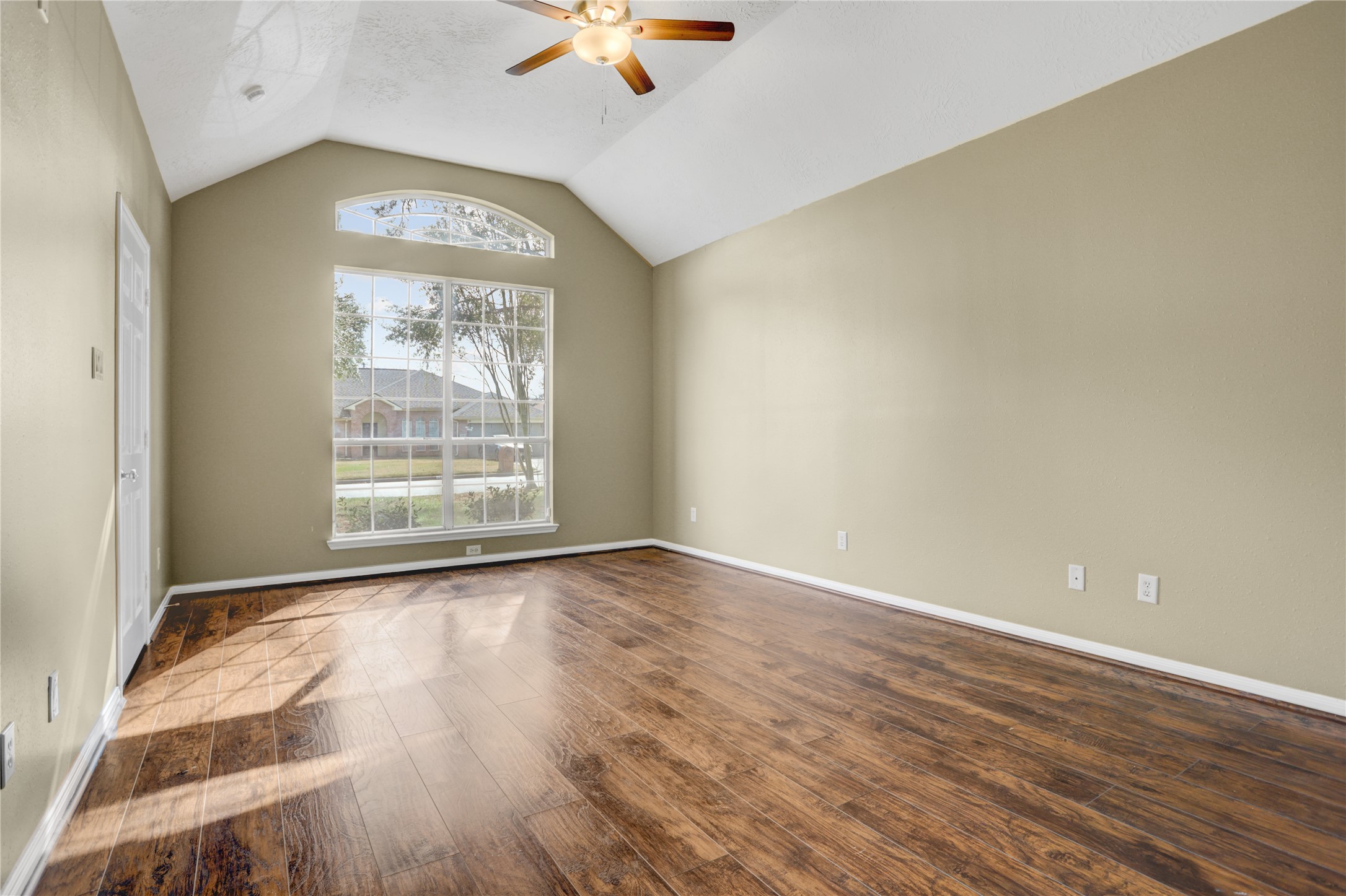 2811 Travick Lane Houston, TX 77073 - Photo 14 of 33 an empty room with wooden floor fan and windows