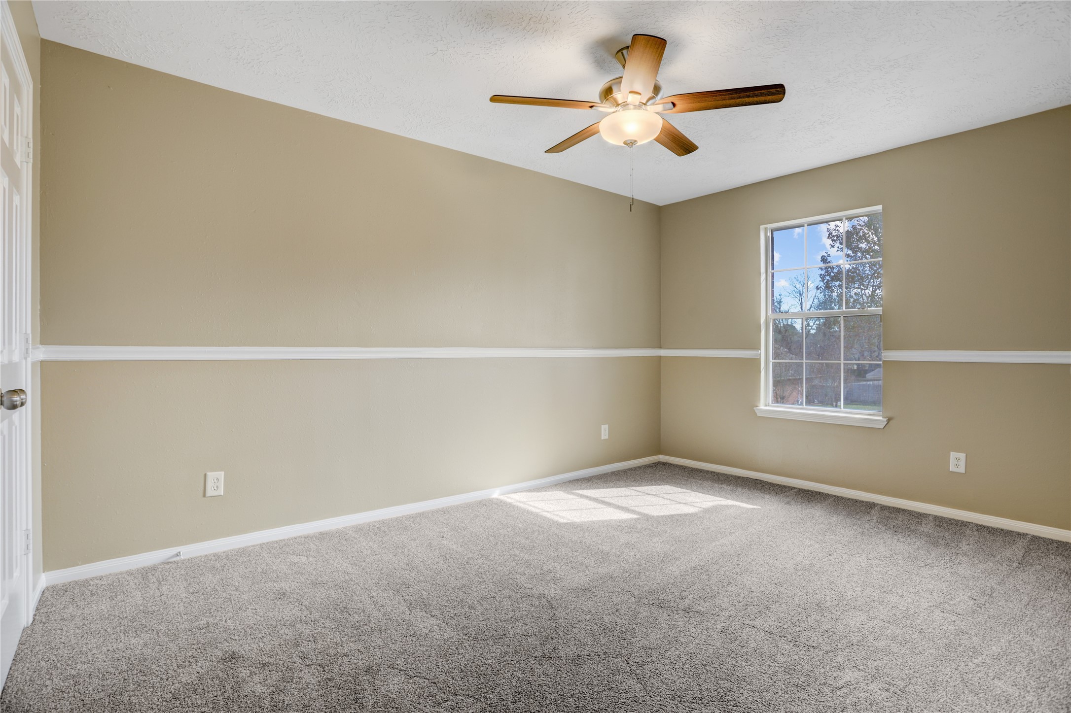 2811 Travick Lane Houston, TX 77073 - Photo 24 of 33 an empty room with a window and a ceiling fan