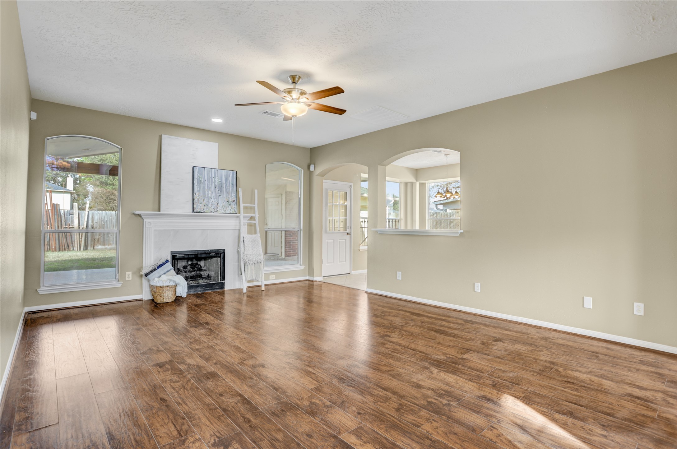 2811 Travick Lane Houston, TX 77073 - Photo 6 of 33 a view of an empty room with a fireplace and wooden floor