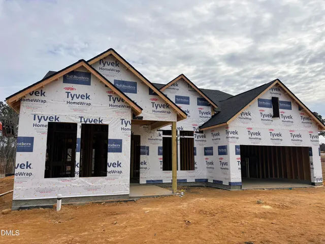 a view of a house with a small yard and large window