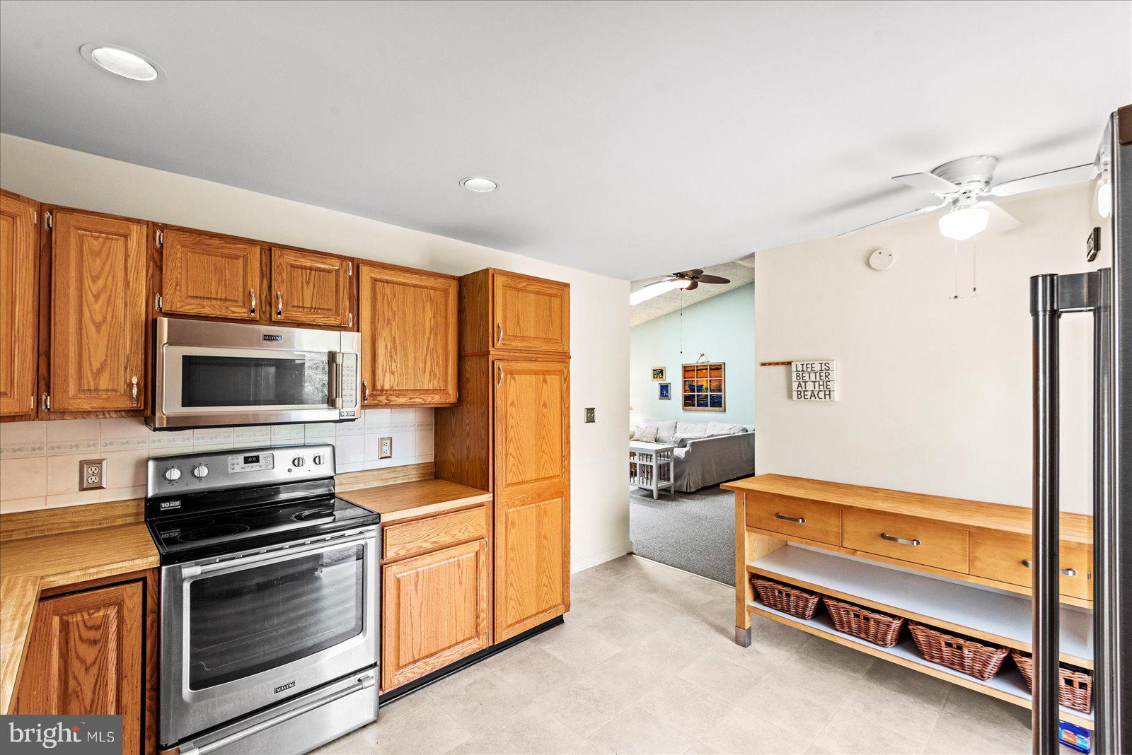 121 11th Street Colonial Beach, VA 22443 - Photo 14 of 33 a kitchen with stainless steel appliances a stove and a refrigerator
