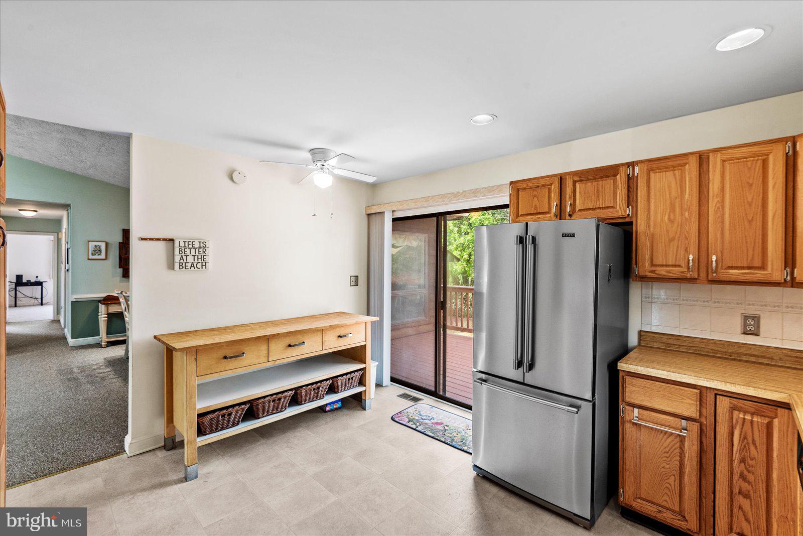 121 11th Street Colonial Beach, VA 22443 - Photo 15 of 33 a kitchen with refrigerator a stove a sink and a cabinets