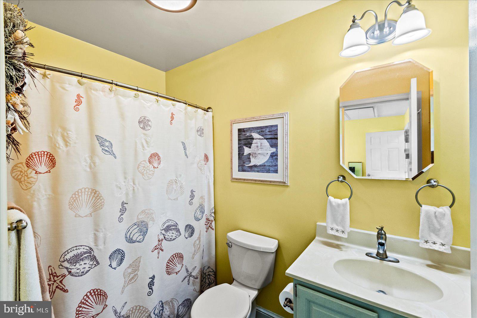 121 11th Street Colonial Beach, VA 22443 - Photo 18 of 33 a bathroom with a sink mirror and a toilet