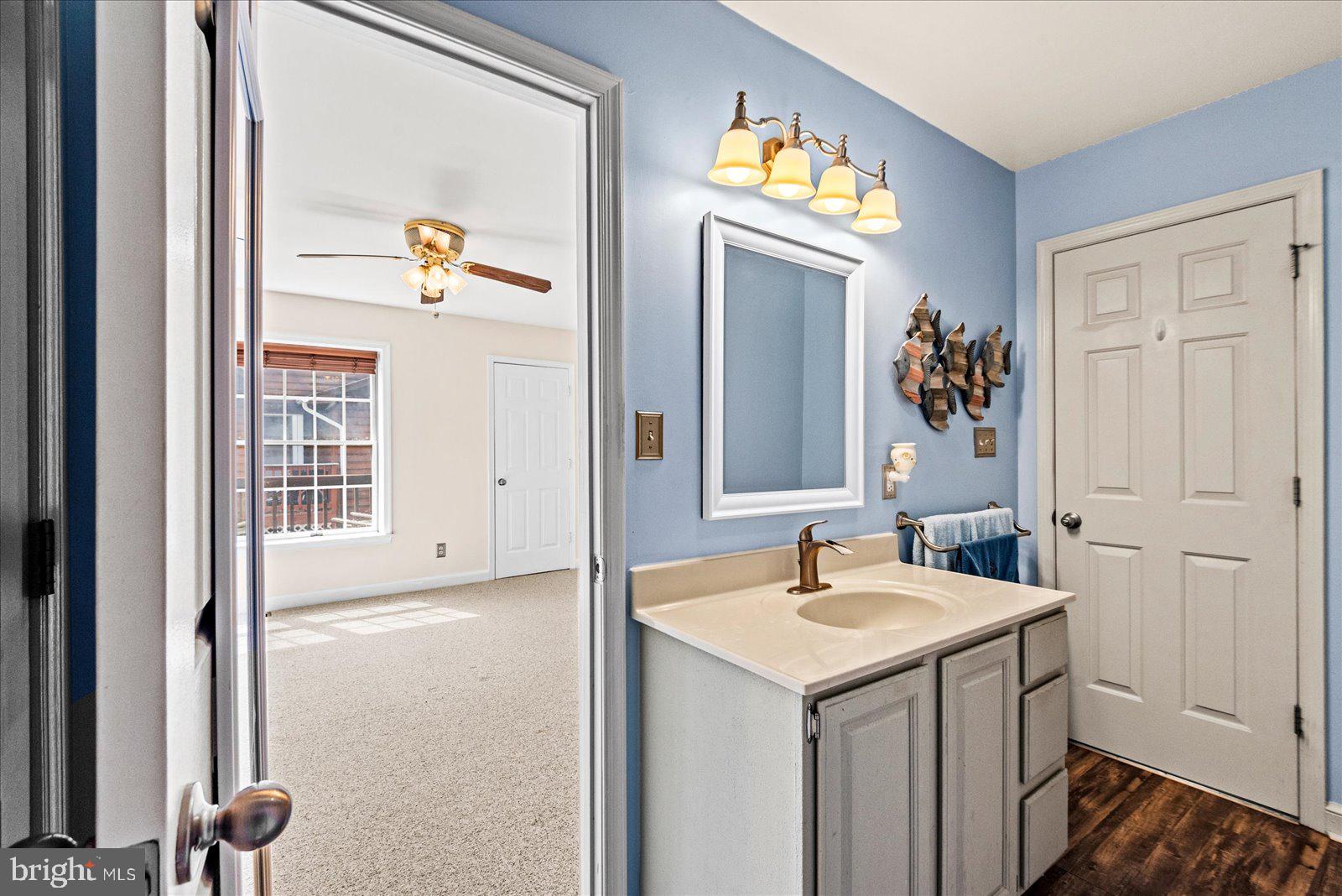 121 11th Street Colonial Beach, VA 22443 - Photo 22 of 33 a bathroom with a sink and a mirror