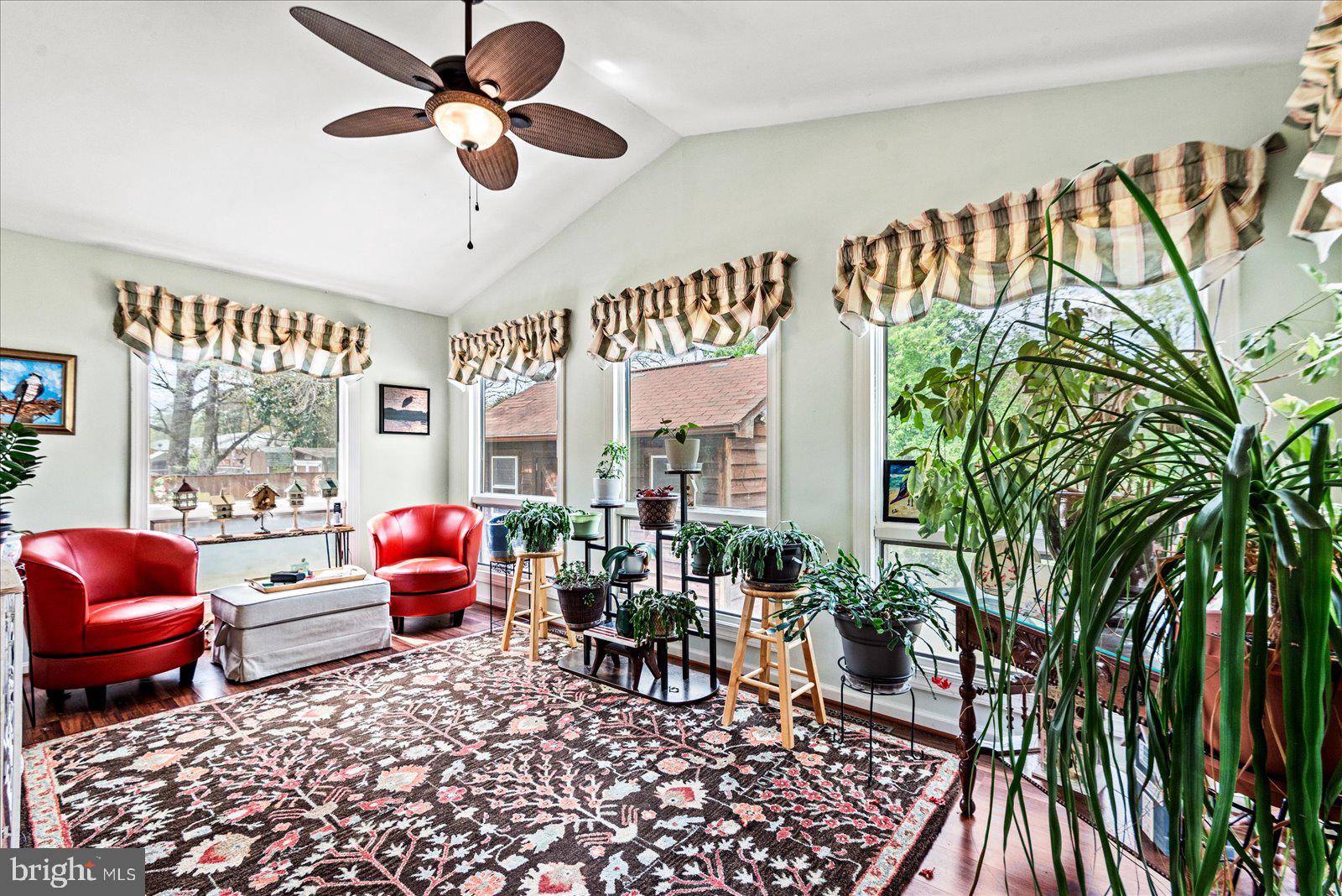 121 11th Street Colonial Beach, VA 22443 - Photo 26 of 33 a living room with furniture floor to ceiling window and a rug