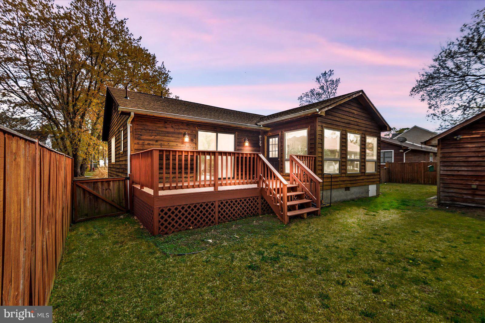 121 11th Street Colonial Beach, VA 22443 - Photo 28 of 33 a backyard of a house with a garden and deck