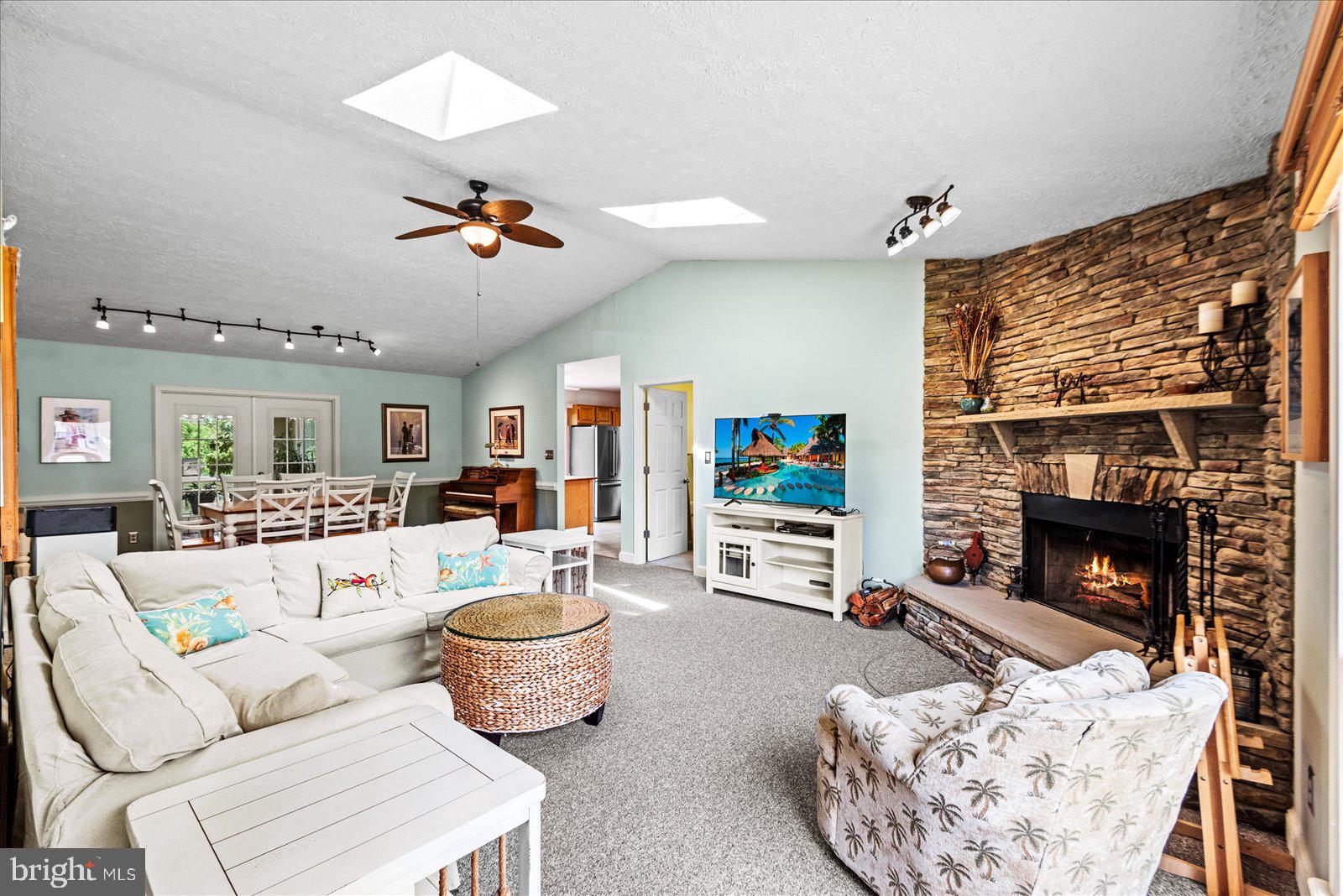 121 11th Street Colonial Beach, VA 22443 - Photo 5 of 33 a living room with furniture a fireplace and a flat screen tv