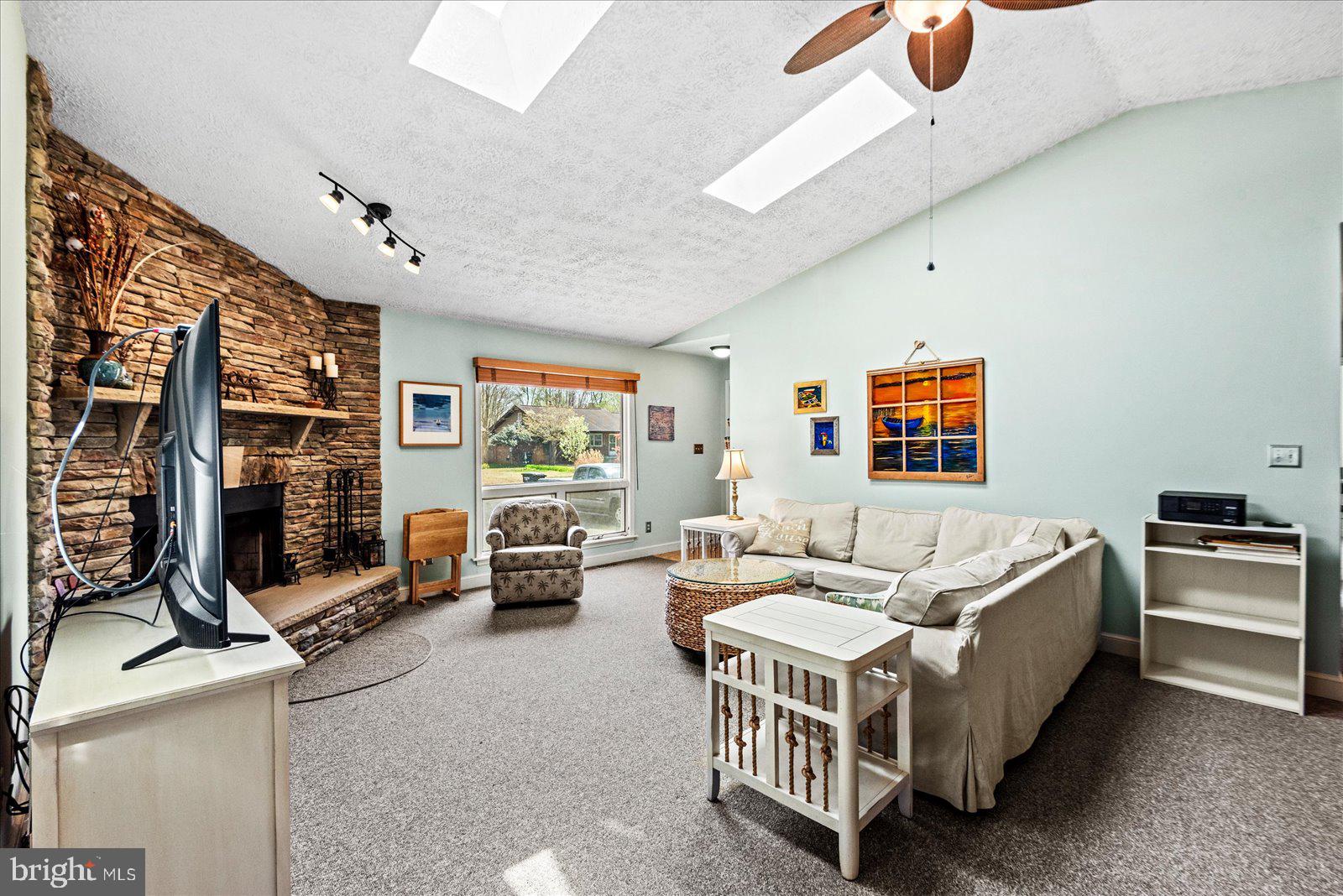 121 11th Street Colonial Beach, VA 22443 - Photo 7 of 33 a spacious bedroom with a bed couch and a large window