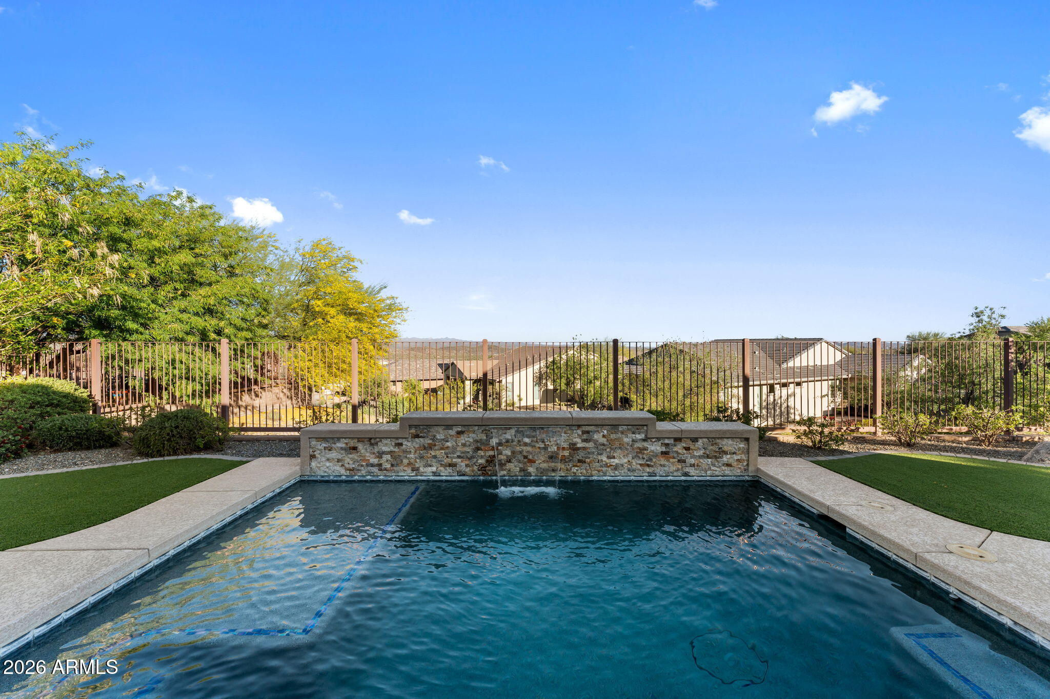 3675 Gold Ridge Road Wickenburg, AZ 85390 - Photo 40 of 58 a view of a lake with a house in the background