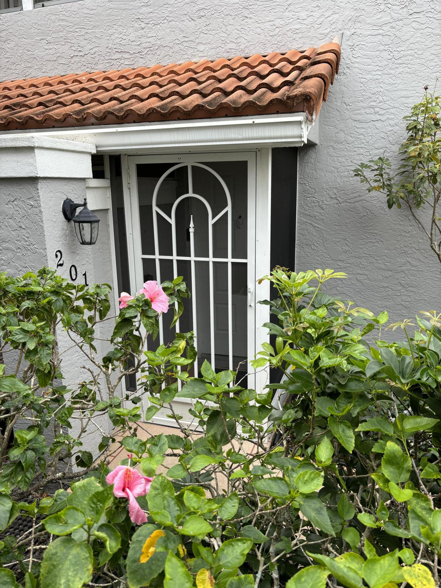 a front view of a house with flowers