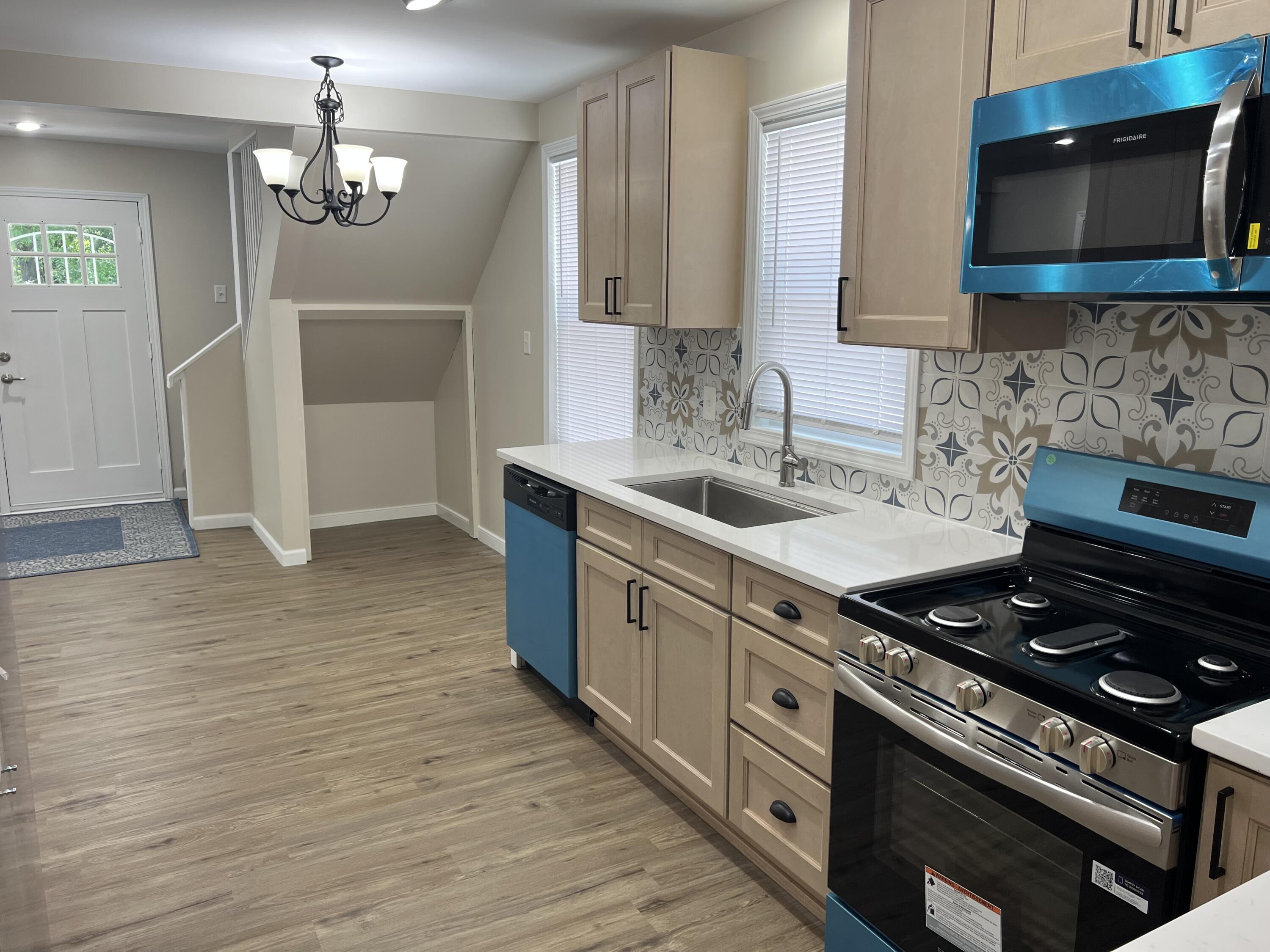 3851 Maple Street Hobart, IN 46342 - Photo 16 of 28 a kitchen with stainless steel appliances a sink stove and microwave
