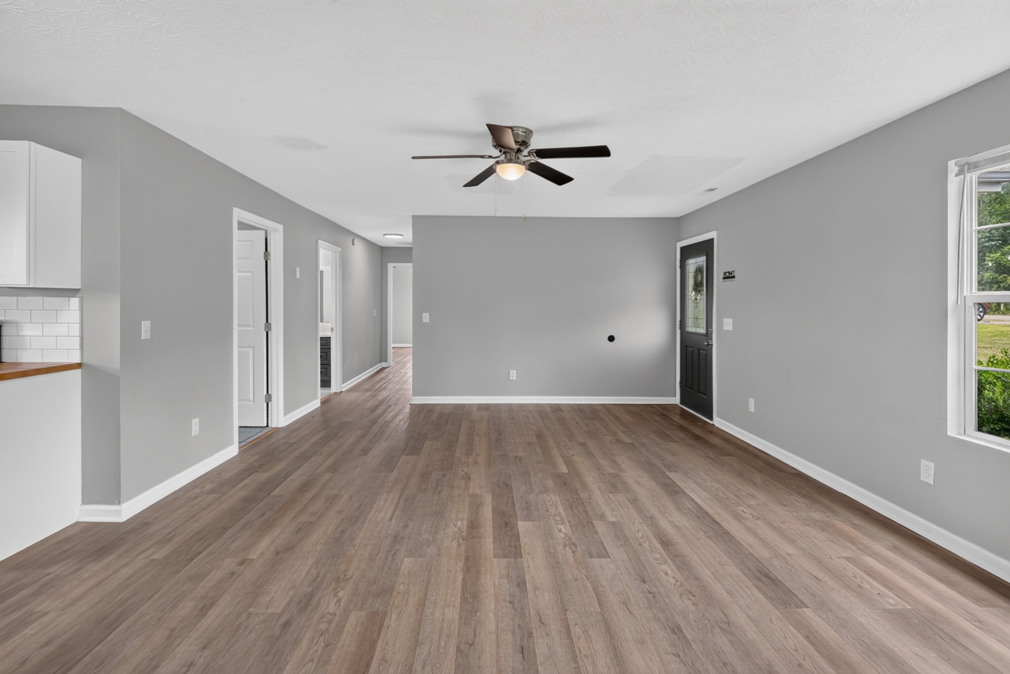 120 Driver Road Lafayette, TN 37083 - Photo 8 of 39 a view of empty room with wooden floor and fan