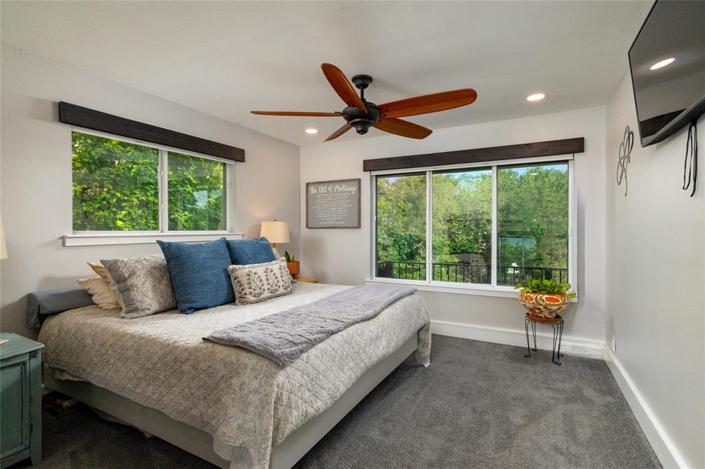 205 Timberlake Drive Azle, TX 76020 - Photo 18 of 40 a bedroom with a large bed and a large window