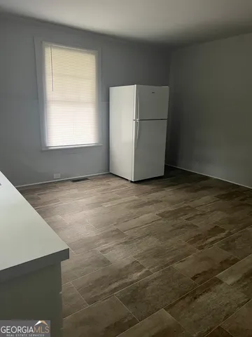a view of an empty room with closet