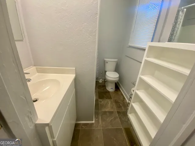 a bathroom with a sink and a toilet