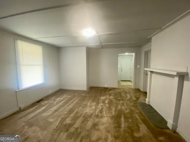 a view of storage and utility room with wooden floor