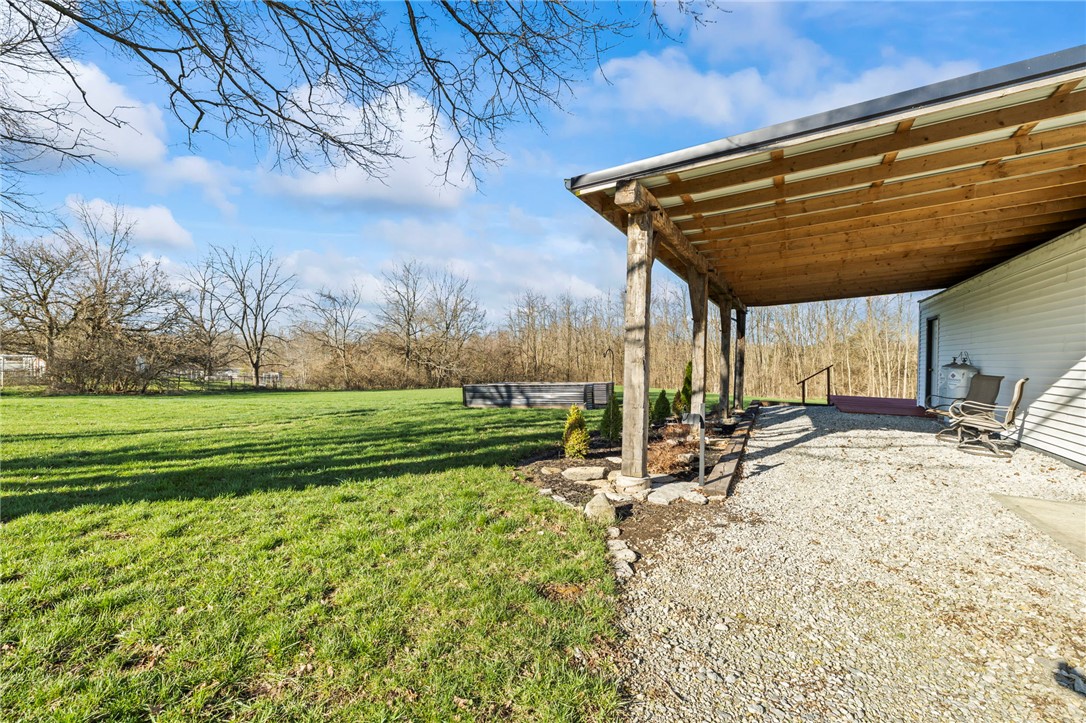 10797 Gratis Jacksonburg Road Somerville, OH 45064 - Photo 22 of 27 This property features a charming patio area and expansive green space, ideal for outdoor enjoyment.